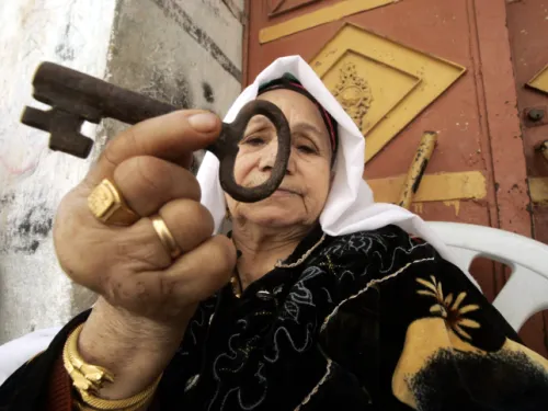Palestinian woman holding a key, a symbol of the right of return for Palestinian refugees