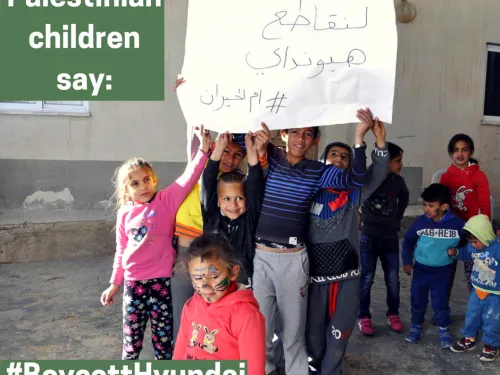 Children from the village of Umm al-Hiran, facing the imminent demolition of their homes by Israeli authorities using Hyundai bulldozers, carry signs saying, "Let's boycott Hyundai  #Umm Al-Hiran" (Credit: Sahar Rouhana, 2017)
