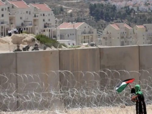 Wall settlements woman flag thumbnail 5.21.2020.png