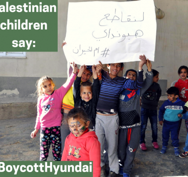 Children from the village of Umm al-Hiran, facing the imminent demolition of their homes by Israeli authorities using Hyundai bulldozers, carry signs saying, "Let's boycott Hyundai  #Umm Al-Hiran" (Credit: Sahar Rouhana, 2017)