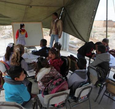 Palestinian students have their lessons inside a tent after Israeli forces demolished a primary school in Hebron, West Bank