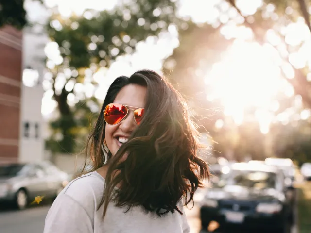Unsplash image of a person with sunglasses simling